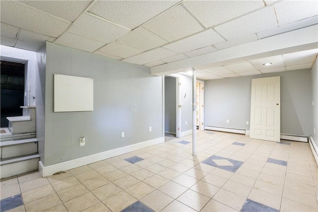 103 Henrietta St, Providence, RI 02904 - basement with a paneled ceiling, baseboard heating, baseboards, and tile patterned floors