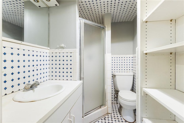 103 Henrietta St, Providence, RI 02904 - bathroom featuring toilet, tile walls, vanity, a shower stall, and wainscoting