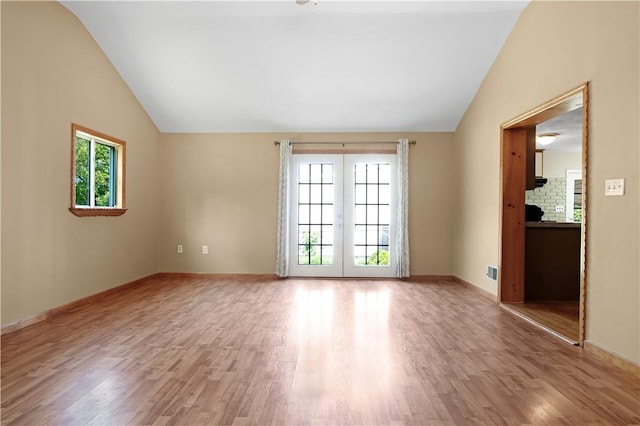 295 Chestnut St, Warwick, RI 02888 - spare room with vaulted ceiling, wood finished floors, french doors, and baseboards