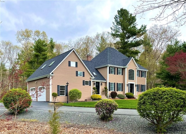 40 King Philip Dr, Rehoboth, MA 2769 - view of front of home featuring asphalt driveway, a chimney, a front lawn, and roof with shingles