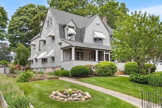 59 Woodland Rd, Woonsocket, RI 02895 - shingle-style home featuring a chimney, a front yard, and roof with shingles