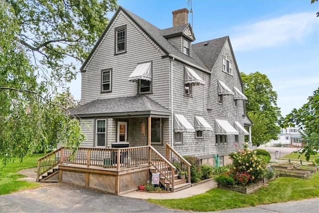 59 Woodland Rd, Woonsocket, RI 02895 - view of front of house with roof with shingles, a chimney, and a front yard