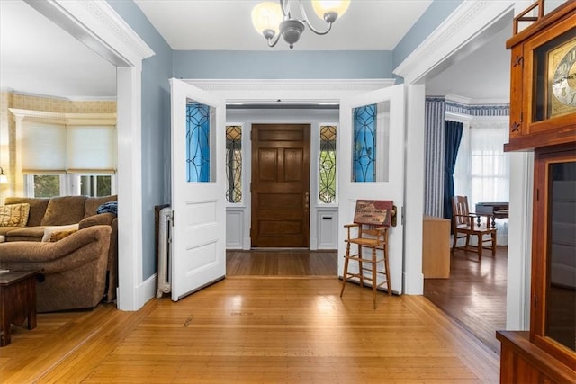 59 Woodland Rd, Woonsocket, RI 02895 - entrance foyer with a chandelier and light wood finished floors