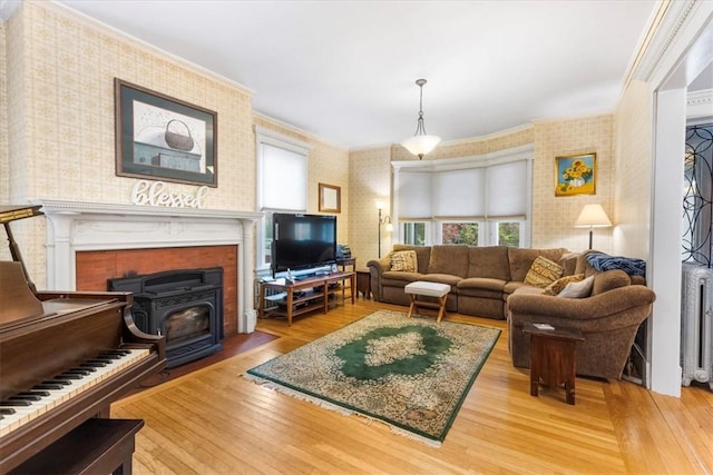 59 Woodland Rd, Woonsocket, RI 02895 - living area with plenty of natural light, ornamental molding, wood finished floors, wallpapered walls, and radiator
