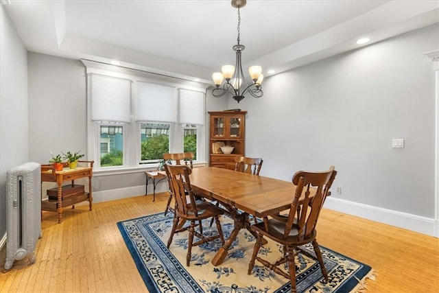 59 Woodland Rd, Woonsocket, RI 02895 - dining room with radiator, baseboards, light wood-style flooring, recessed lighting, and a chandelier