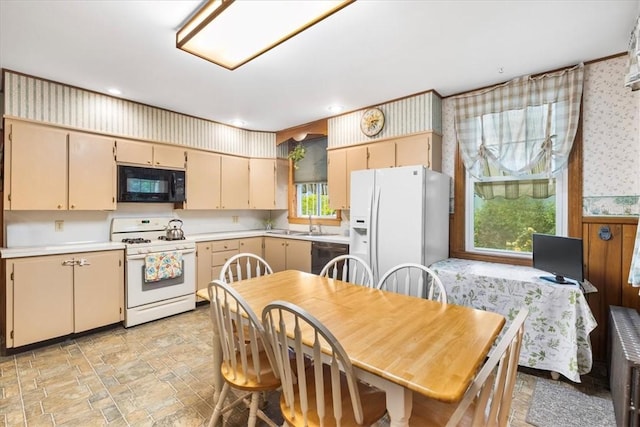 59 Woodland Rd, Woonsocket, RI 02895 - kitchen with black appliances, light countertops, cream cabinets, wallpapered walls, and stone finish flooring