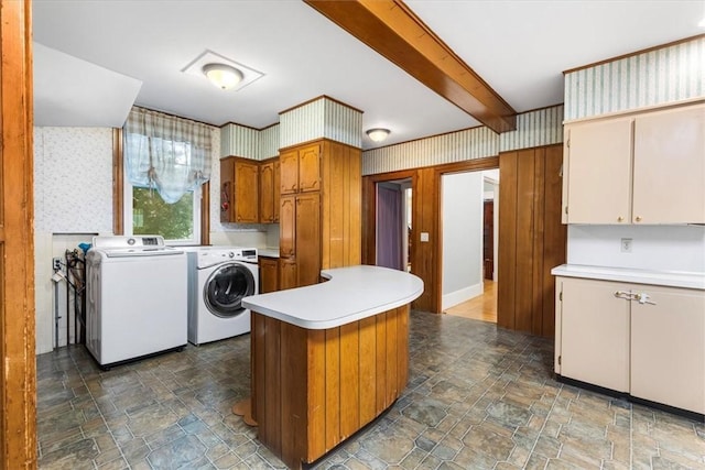 59 Woodland Rd, Woonsocket, RI 02895 - kitchen featuring independent washer and dryer, stone finish flooring, wallpapered walls, light countertops, and beam ceiling