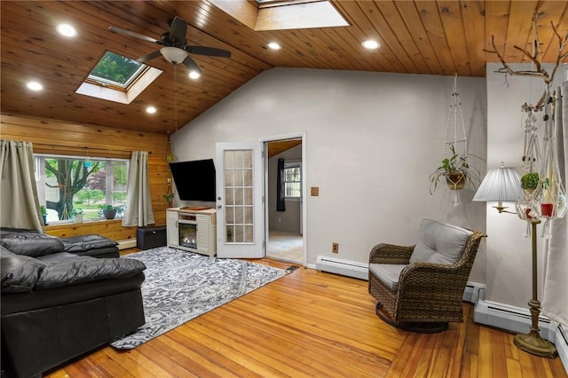 16 Spectacle Ave, Warwick, RI 02888 - living room featuring a skylight, a baseboard heating unit, a ceiling fan, hardwood / wood-style floors, and wooden ceiling