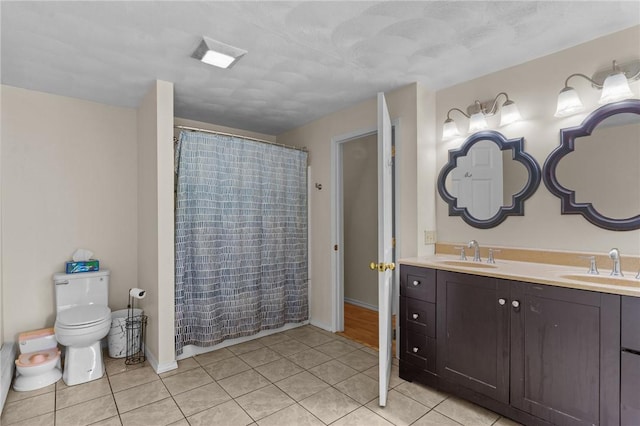 16 Spectacle Ave, Warwick, RI 02888 - bathroom featuring toilet, double vanity, tile patterned floors, baseboards, and a shower with shower curtain