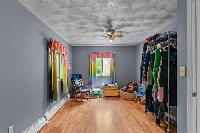 16 Spectacle Ave, Warwick, RI 02888 - living area with a textured ceiling, wood finished floors, and a ceiling fan