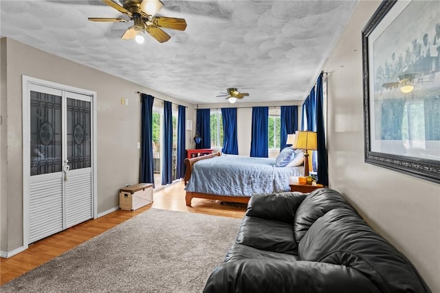 16 Spectacle Ave, Warwick, RI 02888 - bedroom featuring wood finished floors, access to outside, ceiling fan, a textured ceiling, and baseboards