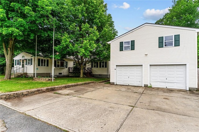 16 Spectacle Ave, Warwick, RI 02888 - view of front of house with a garage, concrete driveway, and a front yard