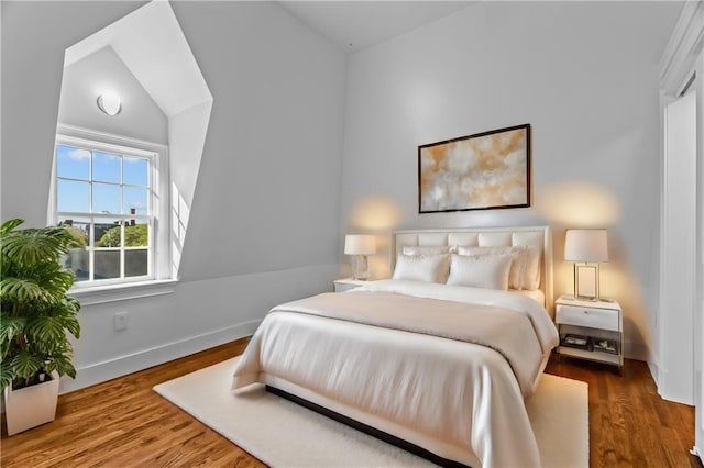18 State St Unit 3E, Bristol, RI 02809 - bedroom with wood finished floors, baseboards, and lofted ceiling