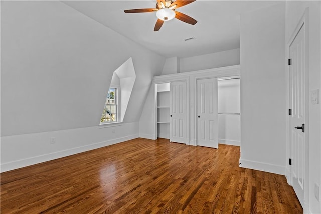 18 State St Unit 3E, Bristol, RI 02809 - unfurnished bedroom featuring lofted ceiling, wood finished floors, baseboards, ceiling fan, and multiple closets