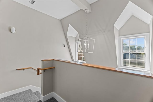 18 State St Unit 3E, Bristol, RI 02809 - stairway featuring vaulted ceiling, a chandelier, baseboards, and carpet