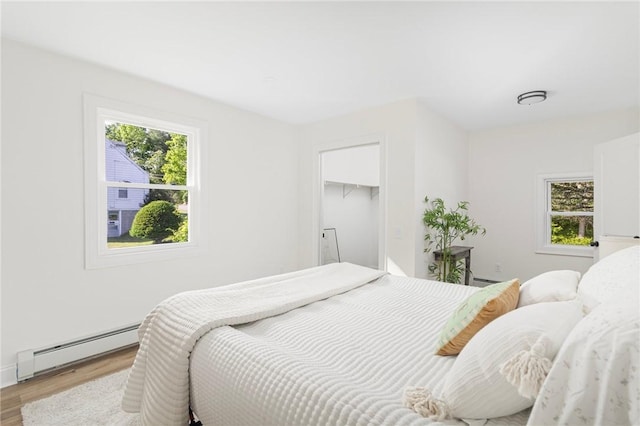 126 Weaver Hill Rd, West Greenwich, RI 02817 - bedroom with a baseboard radiator and light wood finished floors