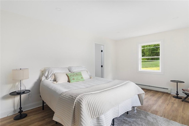 126 Weaver Hill Rd, West Greenwich, RI 02817 - bedroom with a baseboard heating unit, wood finished floors, and baseboards