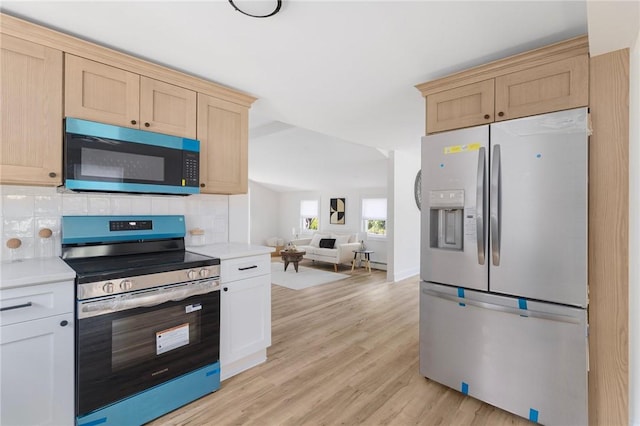126 Weaver Hill Rd, West Greenwich, RI 02817 - kitchen featuring stainless steel appliances, light countertops, light wood-type flooring, and decorative backsplash