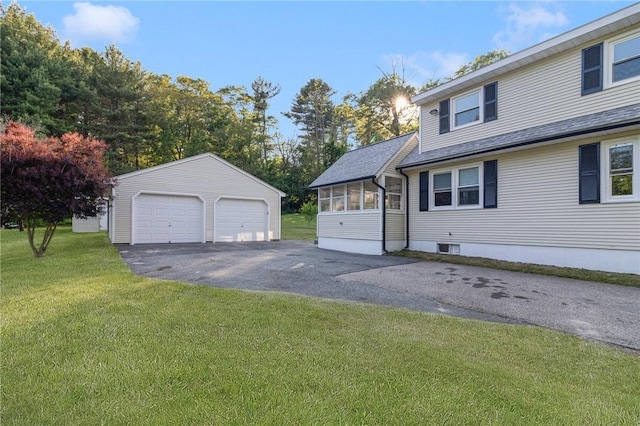 126 Weaver Hill Rd, West Greenwich, RI 02817 - view of home's exterior with a detached garage, an outdoor structure, a lawn, a shingled roof, and a sunroom