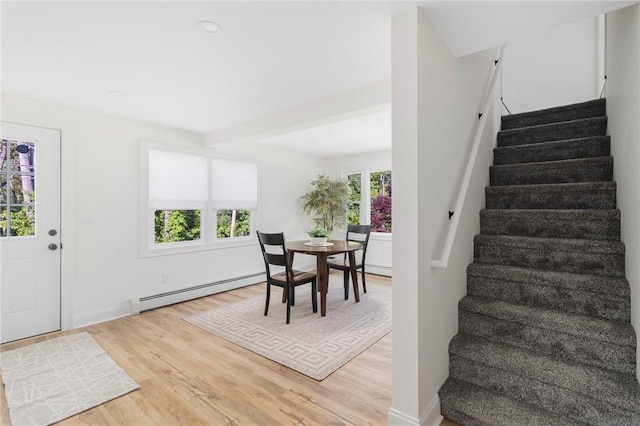 126 Weaver Hill Rd, West Greenwich, RI 02817 - entrance foyer with baseboard heating, stairs, light wood-style flooring, and baseboards