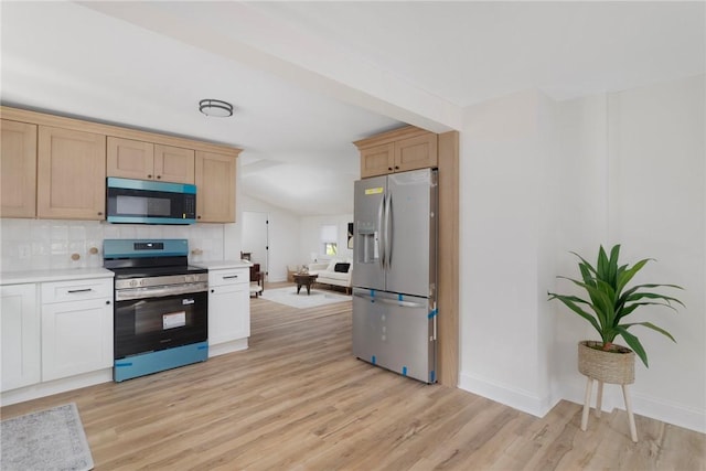 126 Weaver Hill Rd, West Greenwich, RI 02817 - kitchen featuring appliances with stainless steel finishes, light countertops, tasteful backsplash, baseboards, and light wood-style floors