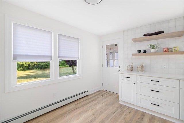 126 Weaver Hill Rd, West Greenwich, RI 02817 - unfurnished dining area with a baseboard heating unit and light wood-type flooring