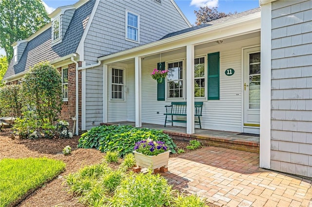 11 Crosswynds Dr, Narragansett, RI 02874 - view of exterior entry with covered porch and a gambrel roof