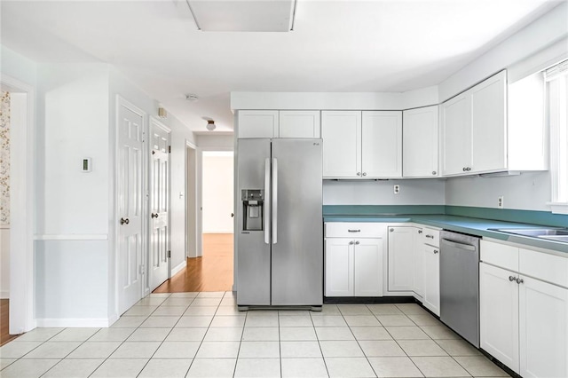 11 Crosswynds Dr, Narragansett, RI 02874 - kitchen with appliances with stainless steel finishes, white cabinetry, light tile patterned flooring, and a sink