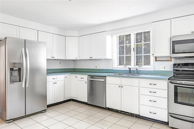 11 Crosswynds Dr, Narragansett, RI 02874 - kitchen featuring stainless steel appliances, a sink, white cabinets, and light tile patterned flooring