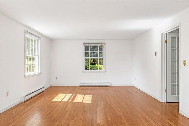 11 Crosswynds Dr, Narragansett, RI 02874 - empty room with baseboard heating, light wood finished floors, and baseboards