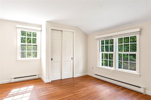 11 Crosswynds Dr, Narragansett, RI 02874 - unfurnished bedroom featuring a baseboard heating unit, wood finished floors, lofted ceiling, and baseboards