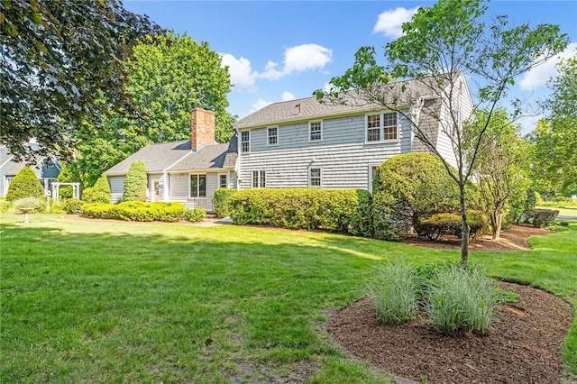 11 Crosswynds Dr, Narragansett, RI 02874 - rear view of property with a lawn and a chimney