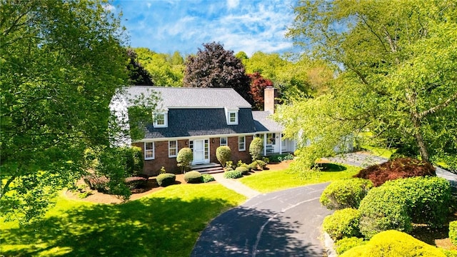 11 Crosswynds Dr, Narragansett, RI 02874 - dutch colonial featuring a chimney, a front lawn, asphalt driveway, and brick siding