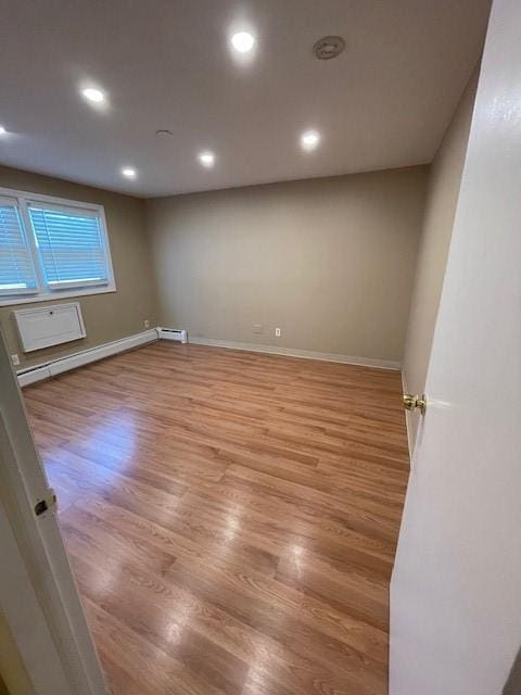 29 Woodbine St Unit 5, Pawtucket, RI 02860 - unfurnished room with a baseboard heating unit, baseboard heating, light wood-style flooring, baseboards, and recessed lighting