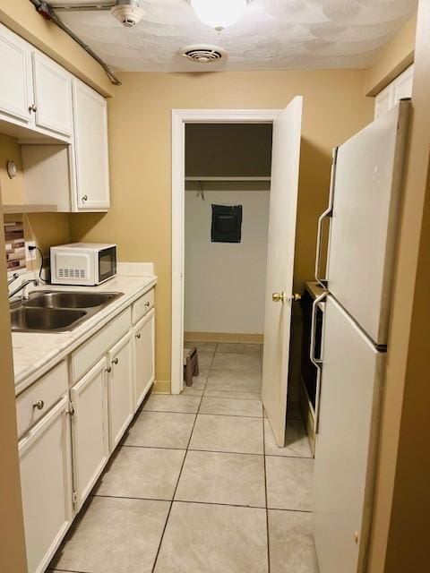 29 Woodbine St Unit 5, Pawtucket, RI 02860 - kitchen with white appliances, white cabinets, light countertops, and a sink