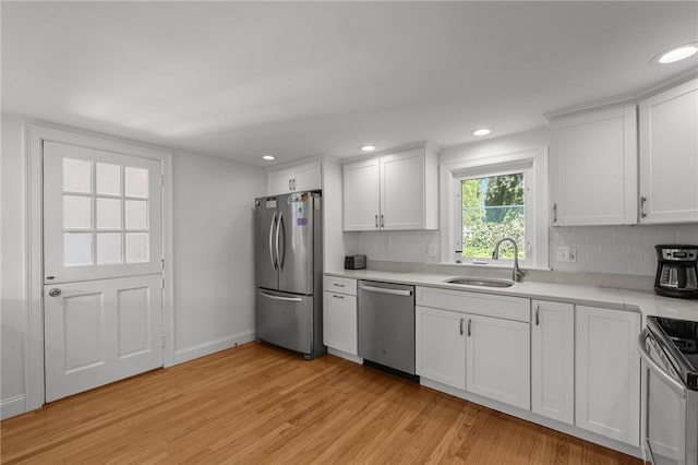 19 Woodsia Rd, Narragansett, RI 02874 - kitchen featuring appliances with stainless steel finishes, a sink, light wood-type flooring, light countertops, and white cabinets