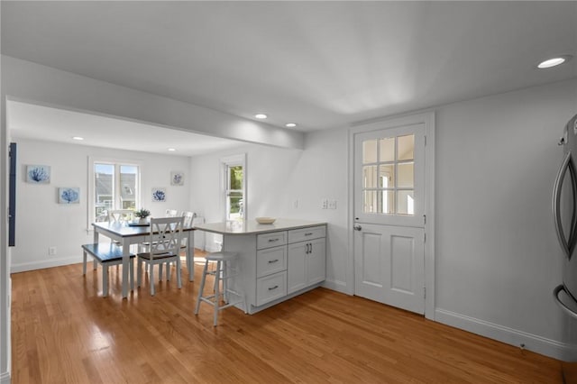 19 Woodsia Rd, Narragansett, RI 02874 - kitchen featuring a peninsula, light wood-style floors, baseboards, recessed lighting, and a breakfast bar