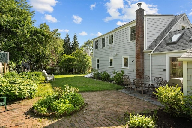 19 Woodsia Rd, Narragansett, RI 02874 - back of property with a patio, roof with shingles, and a chimney
