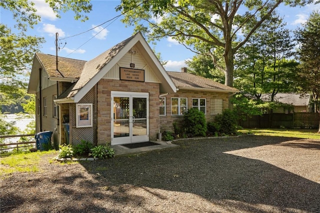 19 Woodsia Rd, Narragansett, RI 02874 - rear view of house with stone siding, french doors, and a shingled roof
