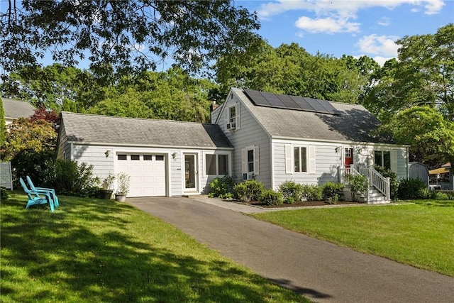 19 Woodsia Rd, Narragansett, RI 02874 - view of front of property featuring a garage, driveway, roof mounted solar panels, a front lawn, and a shingled roof
