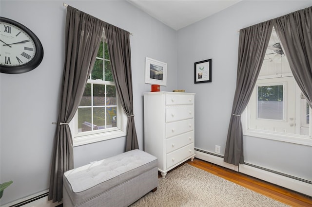 30 Lincoln St, Smithfield, RI 02917 - living area with a baseboard heating unit, wood finished floors, and healthy amount of natural light