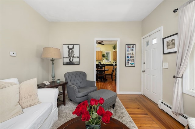 30 Lincoln St, Smithfield, RI 02917 - living room featuring a baseboard heating unit, wood finished floors, baseboards, and ceiling fan