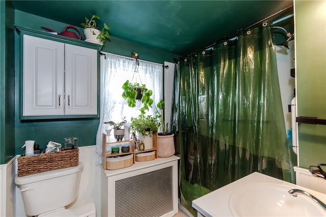 339 Beverage Hill Ave, Pawtucket, RI 02861 - bathroom with toilet, wainscoting, a shower with curtain, and a sink