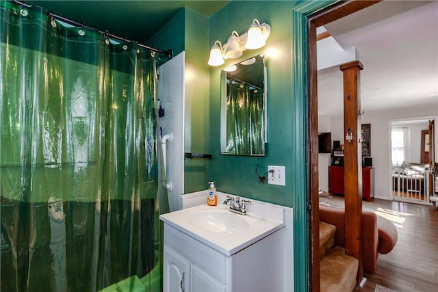 339 Beverage Hill Ave, Pawtucket, RI 02861 - bathroom featuring vanity, decorative columns, wood finished floors, and a shower with curtain