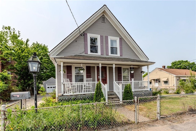 339 Beverage Hill Ave, Pawtucket, RI 02861 - view of front of house featuring covered porch, a fenced front yard, a detached garage, a gate, and an outbuilding