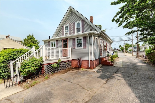 339 Beverage Hill Ave, Pawtucket, RI 02861 - view of front of home featuring a chimney, driveway, and a deck