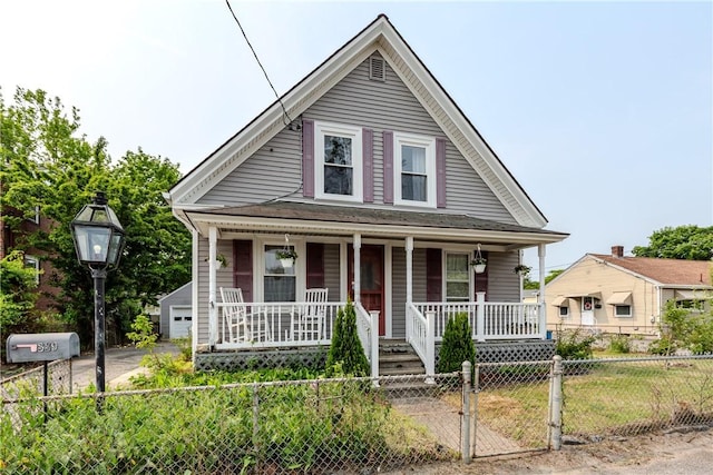 339 Beverage Hill Ave, Pawtucket, RI 02861 - view of front of house with covered porch, a fenced front yard, a detached garage, and a gate