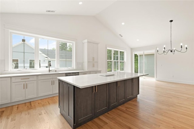 66 Orchard Ave, Johnston, RI 02919 - kitchen featuring lofted ceiling, light countertops, a chandelier, light wood finished floors, and a kitchen island