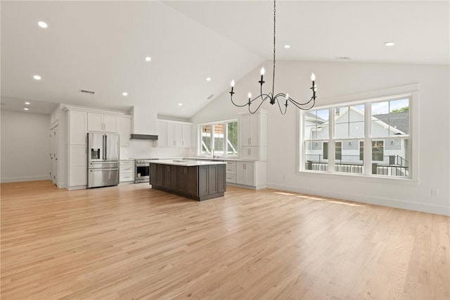 66 Orchard Ave, Johnston, RI 02919 - kitchen featuring appliances with stainless steel finishes, light countertops, a chandelier, white cabinets, and light wood-type flooring