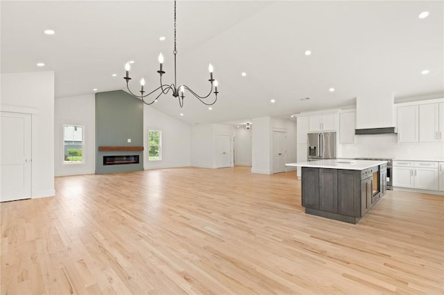 66 Orchard Ave, Johnston, RI 02919 - kitchen featuring stainless steel appliances, white cabinets, a chandelier, open floor plan, and a kitchen island